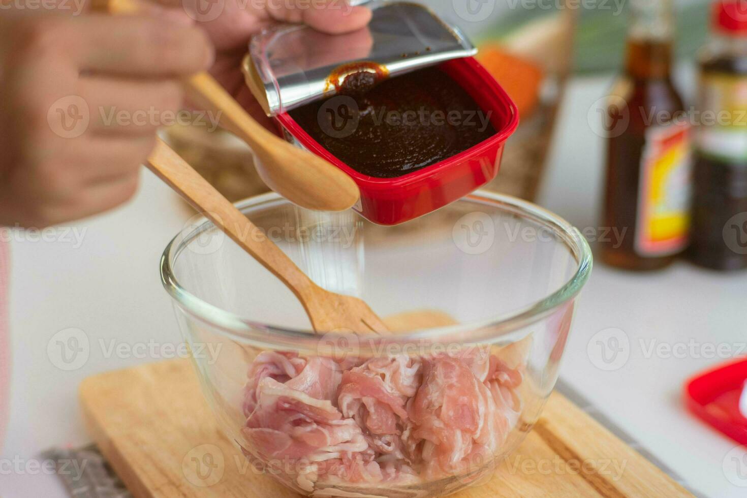 Step-by-step procedures to marinate pork for easy Korean cooking, add chopped onions and Japanese bunching onion, sesame oil, soy sauce, Korean gochujang and mix well. Korean homemade food for lunch photo