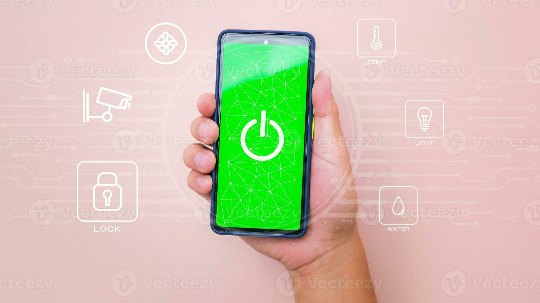 Male hand holding smart phone on pink background with smart home technology interface on smartphone app screen. Concept of automation. photo
