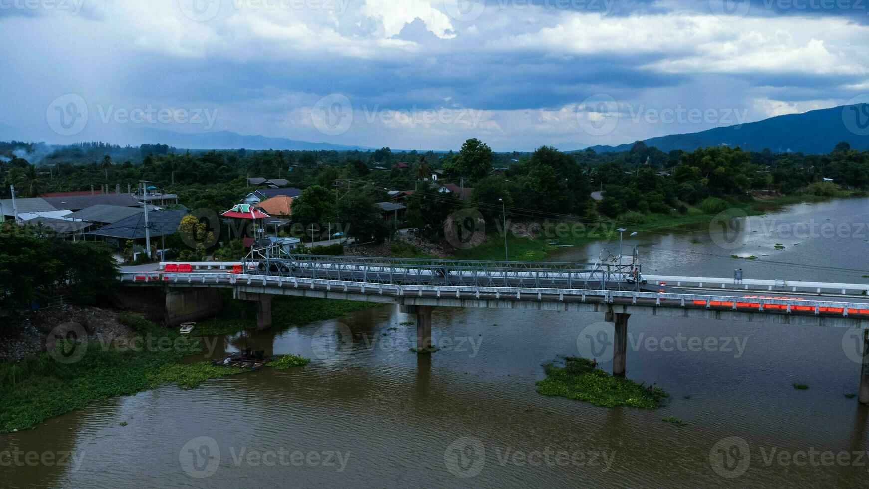 Repair of a concrete bridge across a river in the countryside. Repair of a road section. Aerial view of renovation of the bridge. dangerous passage photo