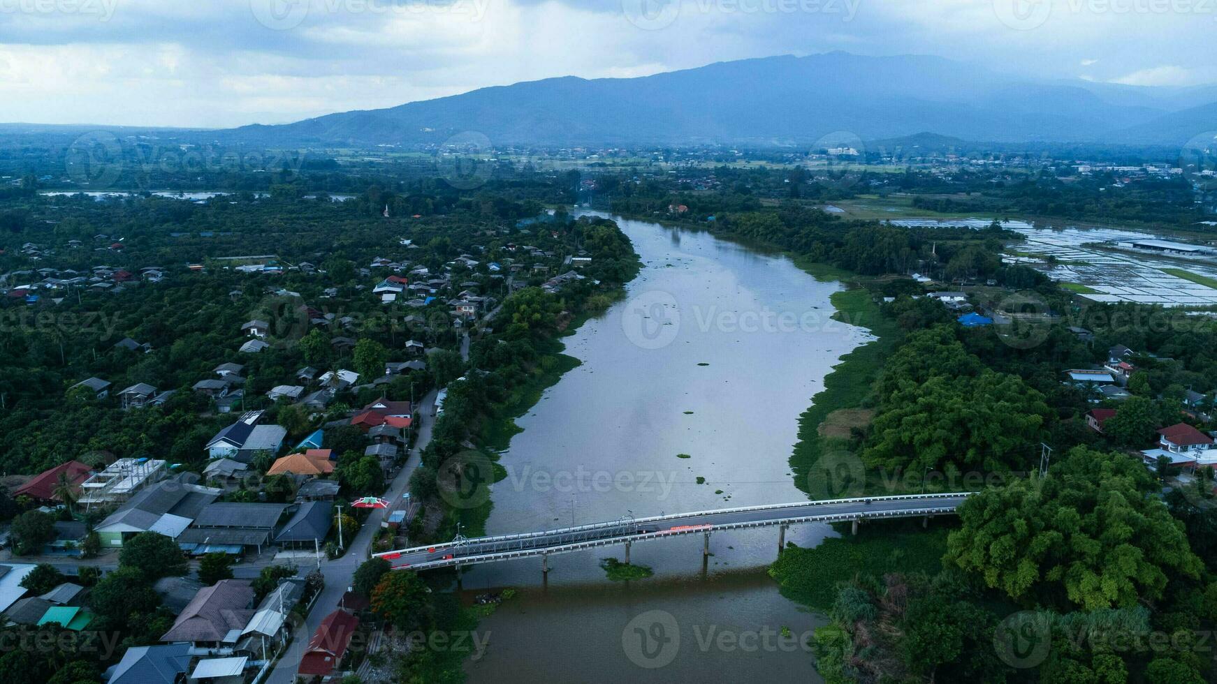 Repair of a concrete bridge across a river in the countryside. Repair of a road section. Aerial view of renovation of the bridge. dangerous passage photo