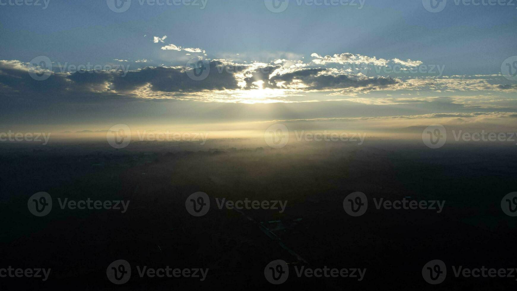 Aerial view of foggy hills covered by forest. Beautiful landscape in the mountains at sunrise. Colourful sunrise in forested mountain with fog. Morning dawn in the mountains. photo