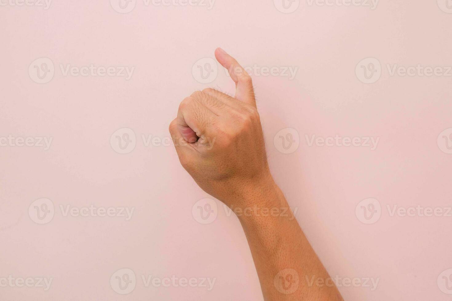 Little finger of male hand against pink background, meaning reconciliation. keeping promise sign. photo