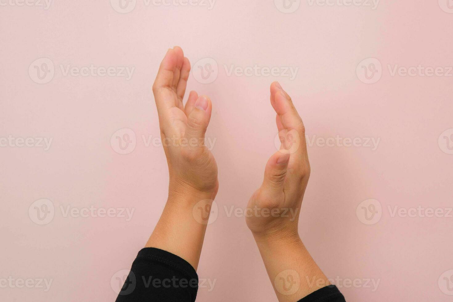 Woman clapping hands isolated on pink background. Close up of female hands applauding. photo