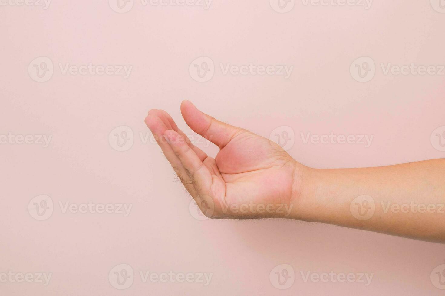 Hands gesture like picking up something isolated on pink background. photo