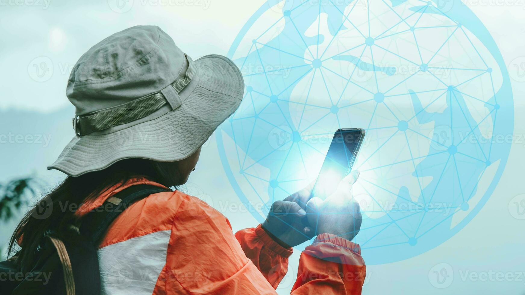 Female ecologists carry a backpack using a map on the phone to explore the forest path. Female botanists work in the field survey with technology on smartphones. photo