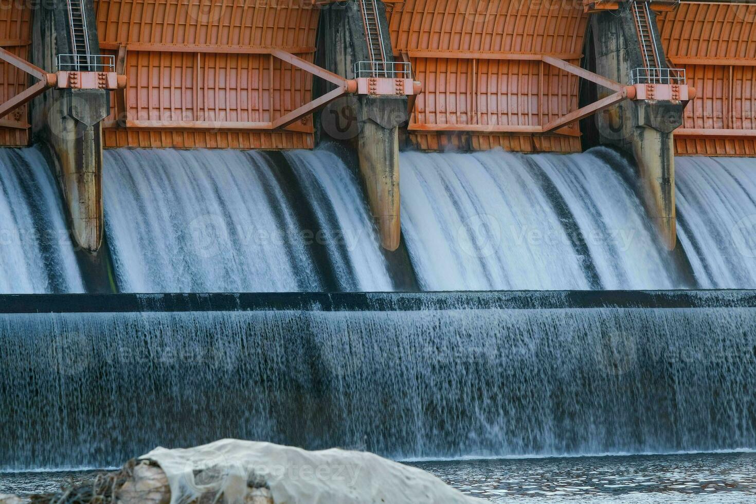 Hydroelectric dam, floodgate with flowing water through gate and open springway at Kew Lom Dam, Lampang, Thailand. Dam photo