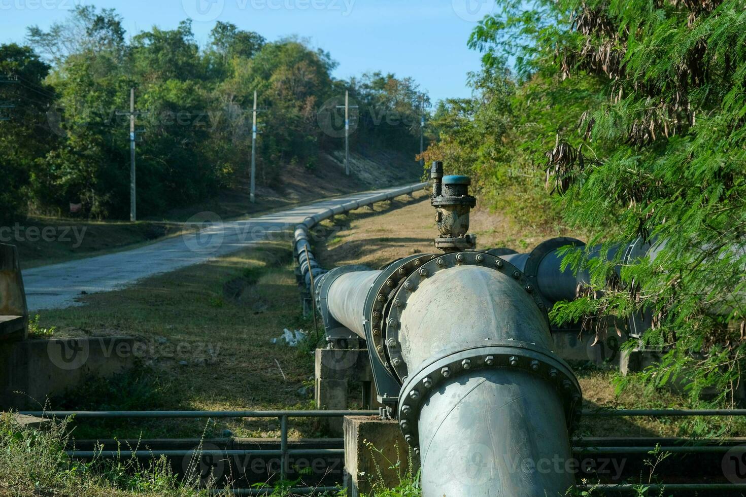 Pipe is installed along the bridge on the pipe support. Water steel pipes for community utilities. photo