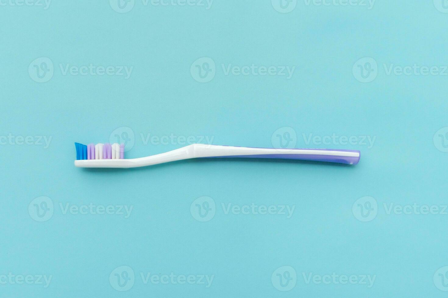 A toothbrush isolated on blue background, after some edits. photo