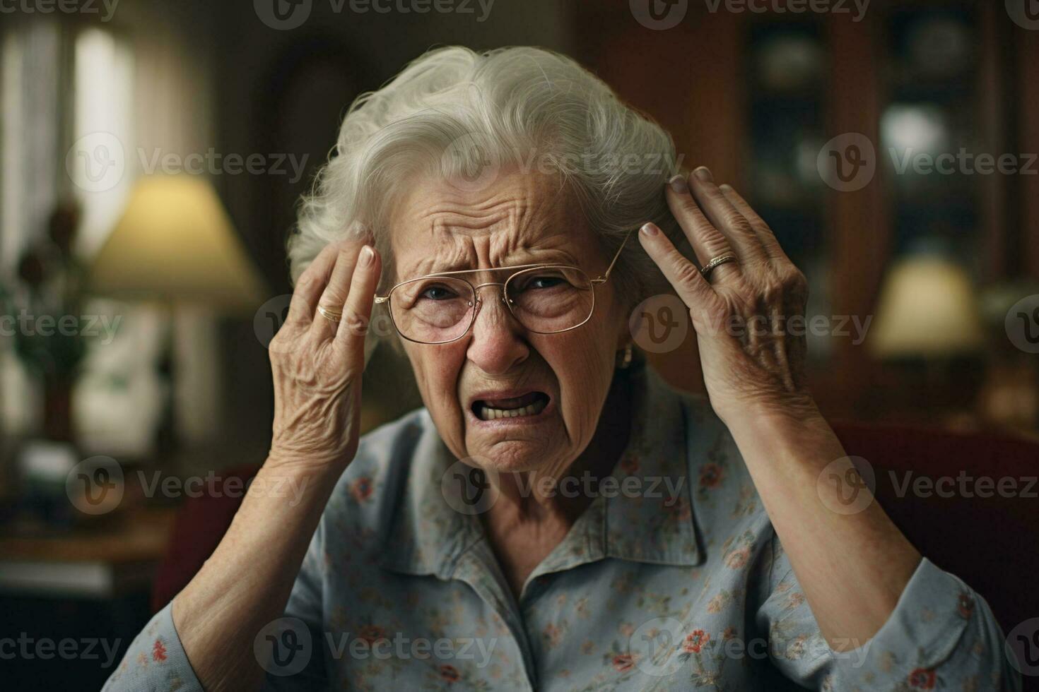 Sick old woman having a headache in the living room during the daytime photo