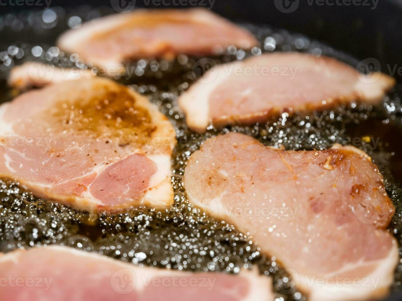 fried bacon in a frying pan. close up photo