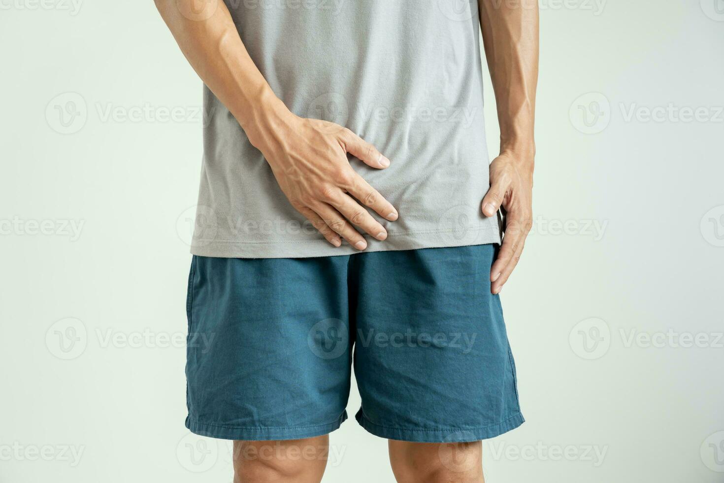 Man hold hand in front of private parts feeling discomfort from disease and inflammation. Venereal, testicular cancer. bladder problems, erectile dysfunction, premature ejaculation, prostate cancer photo