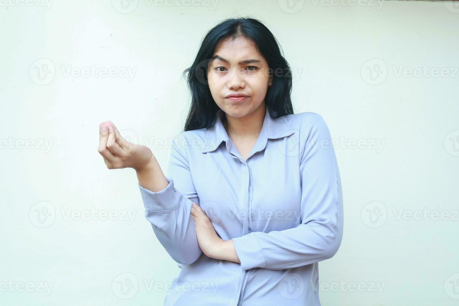 dissatisfied puzzled asian young business woman spreading palm and shrugging shoulders confused looking at camera isolated over white background photo