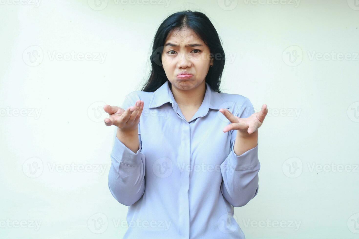 uncertain beautiful asian woman looking at camera and raising hand with open palm have no idea gesture, questioning answer, doubtful decision, isolated on white background wear formal suit photo