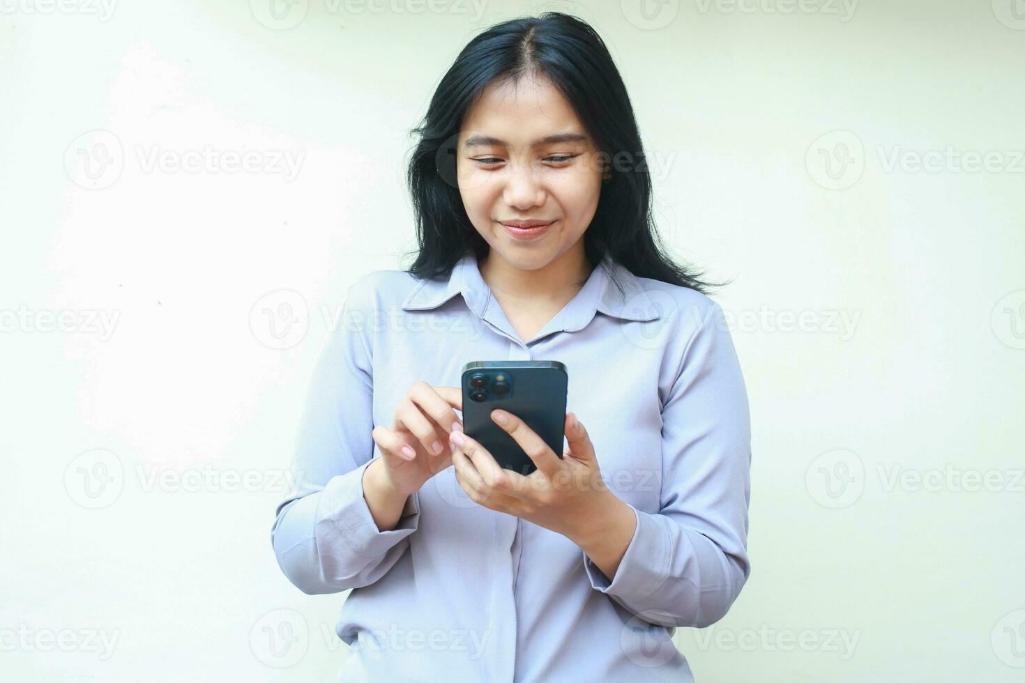 young beautiful asian business woman wear formal shirt look smartphone screen using app, chatting and video calling, enjoy online shopping and read good news, standing over isolated white background photo