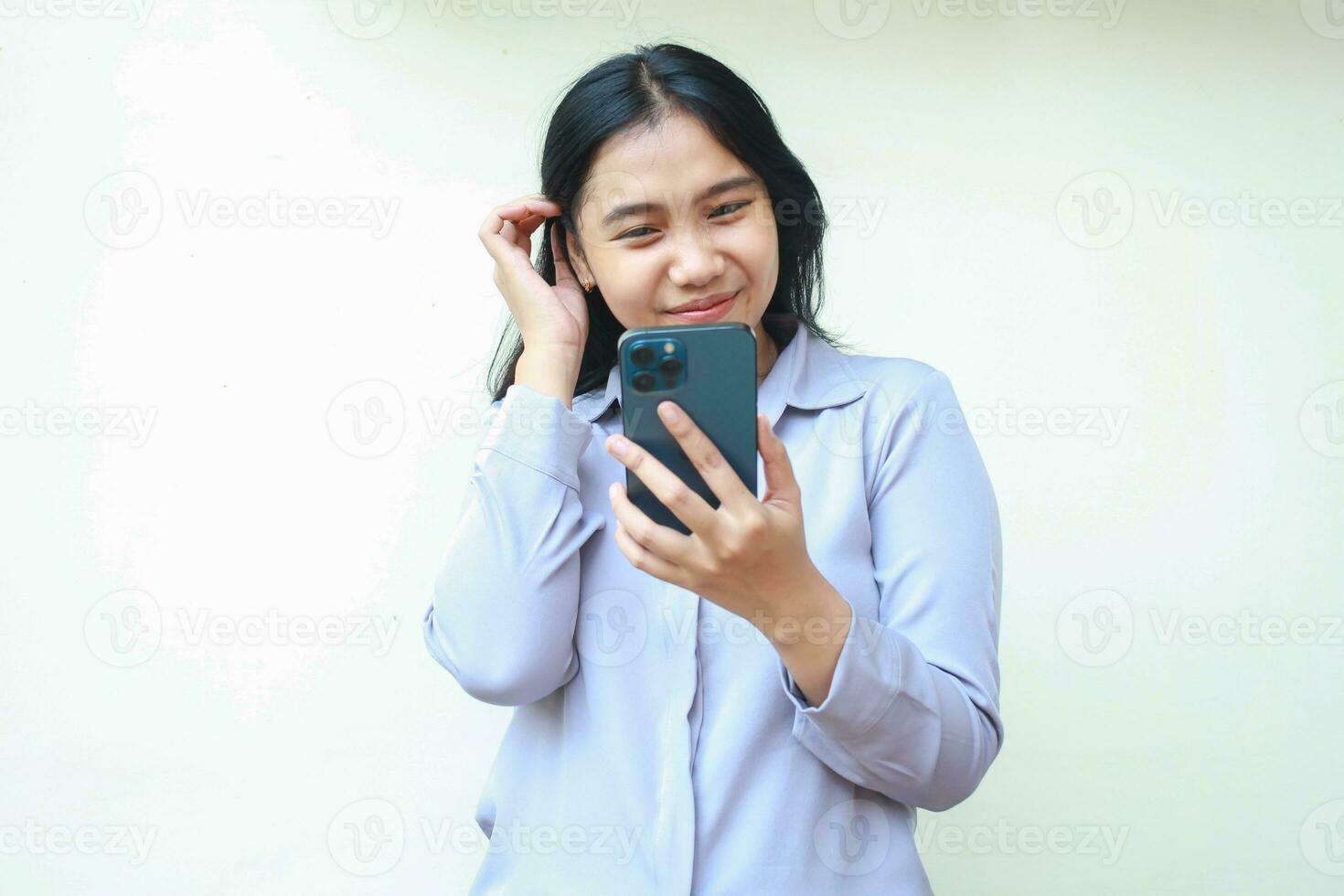 elegant asian young business woman show femininity using smartphone to video call, read good news and social media online shopping, wearing formal shirt standing over white background, looking screen photo