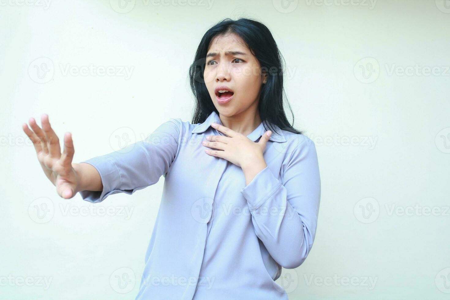 studio shot of stunned asian young beautiful business woman reaching hands towards camera smiling amazed wearing formal office shirt standing over isolated white background photo