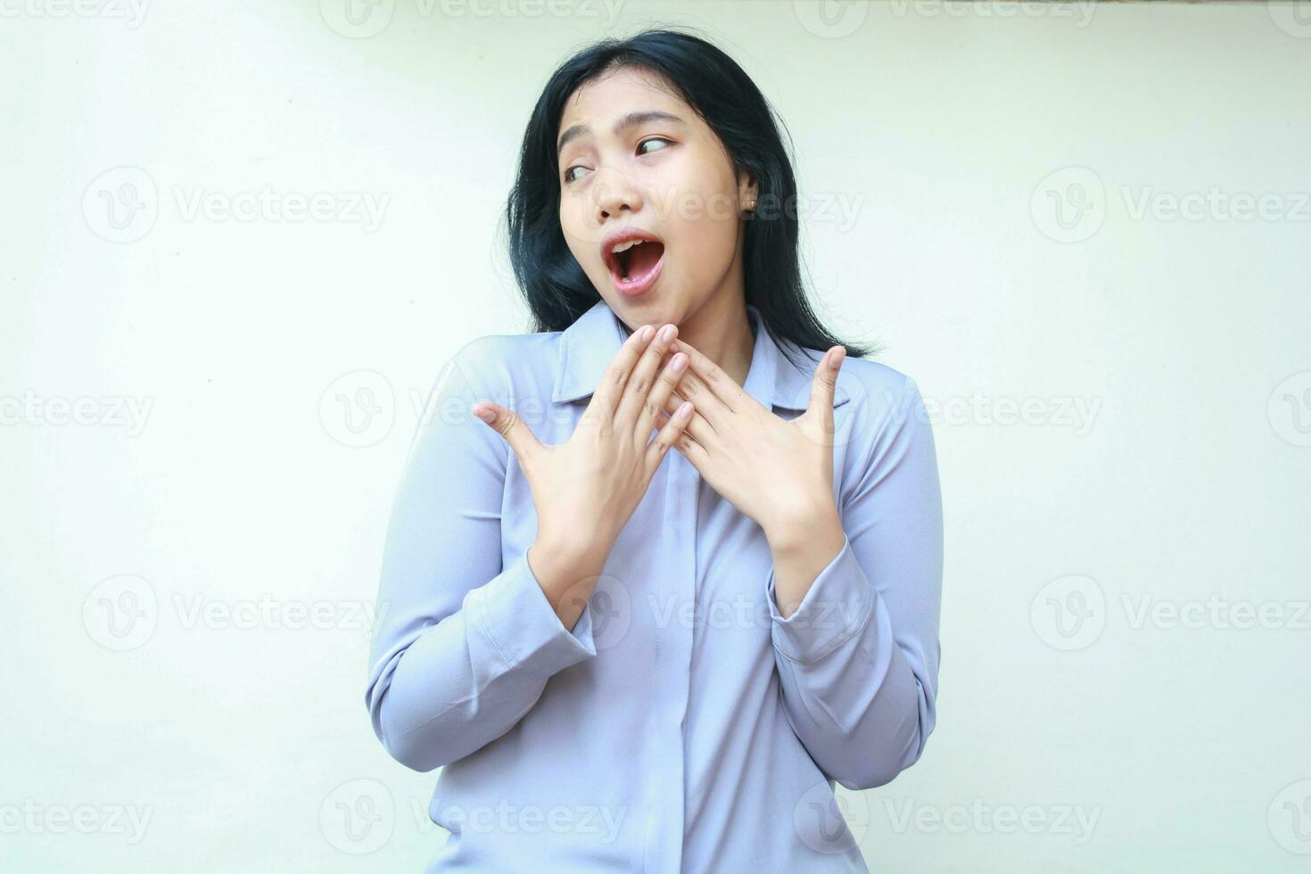 shocked pretty asian young business woman looking away amazed with hands covering mouth wide open wearing formal office clothes standing over isolated white background photo