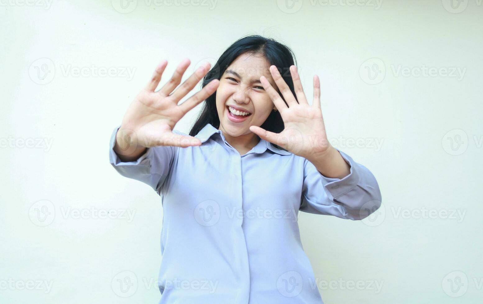 studio shot of stunned asian young beautiful business woman reaching hands towards camera smiling amazed wearing formal office shirt standing over isolated white background photo