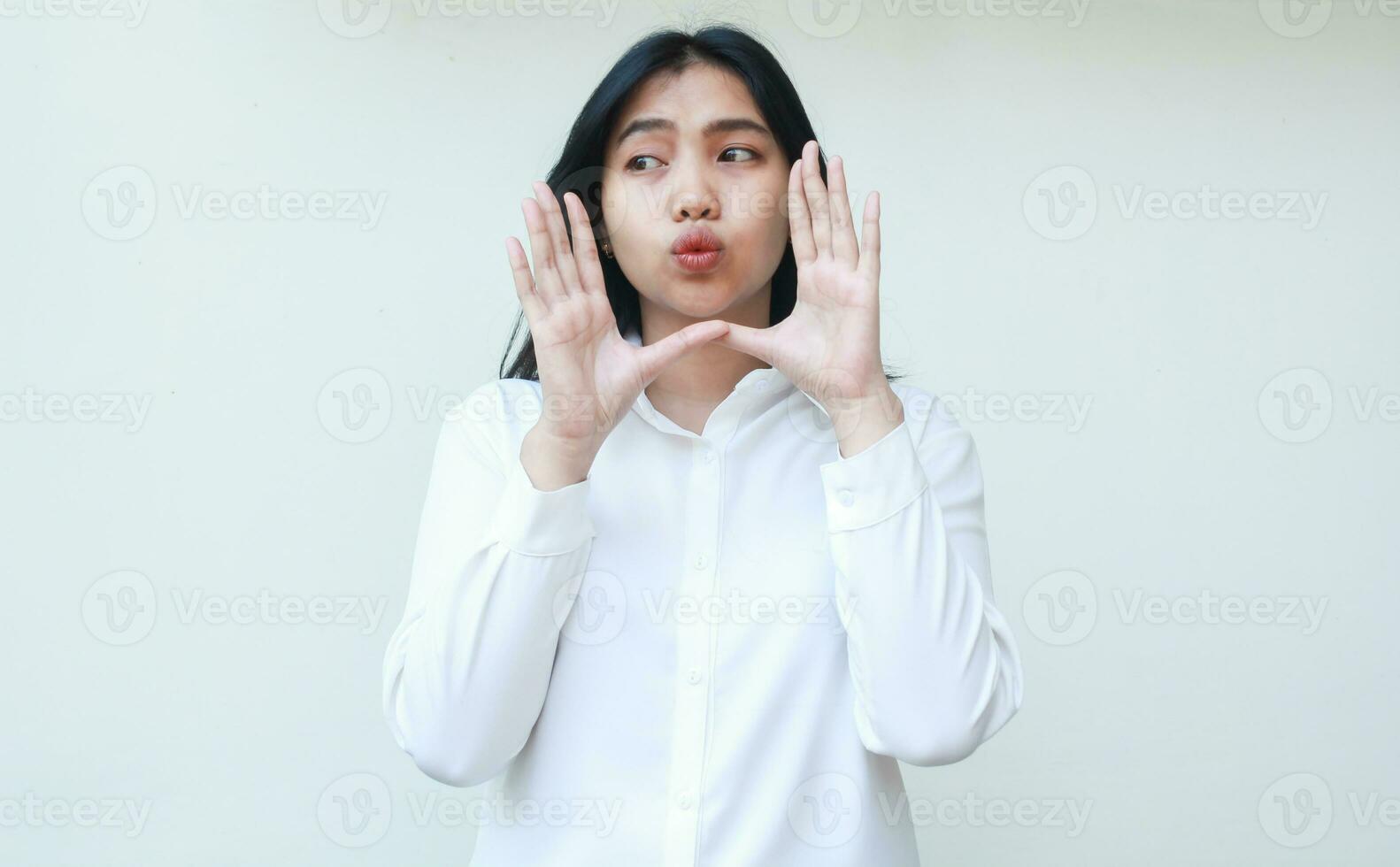 portrait of pensive beautiful asian business woman whispering gossip with kissing lips looking away pondering wear white shirt formal suit standing isolated background photo