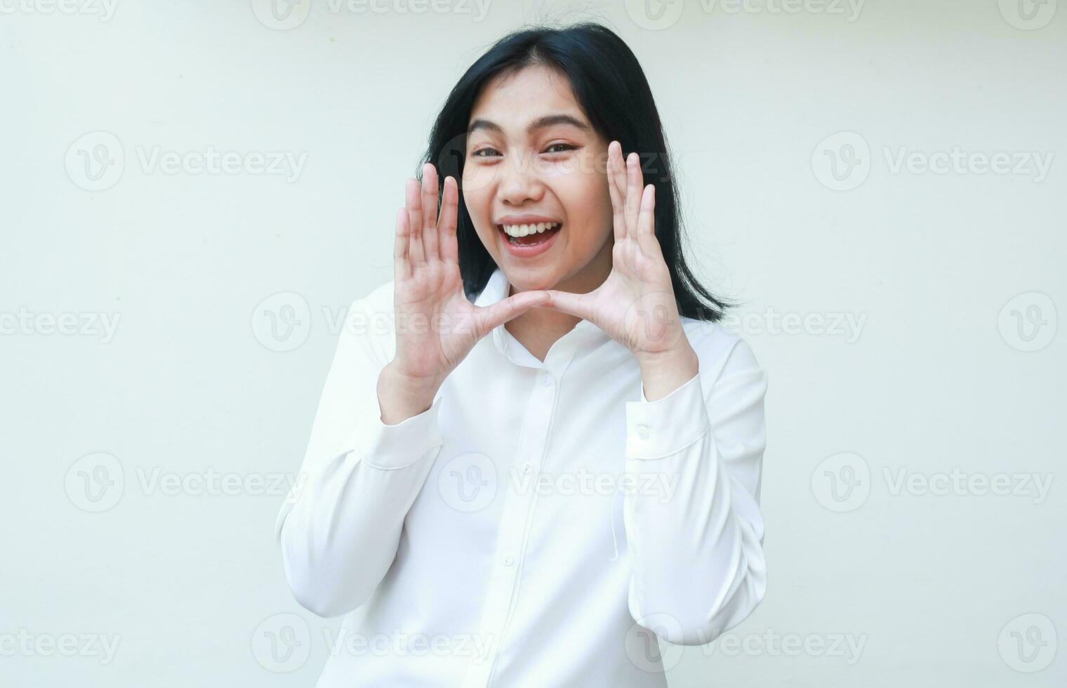 charming beauty cheerful asian business woman shouting at camera with laugh and raised palms announce promotion and new product wearing white shirt formal suit standing isolated background photo