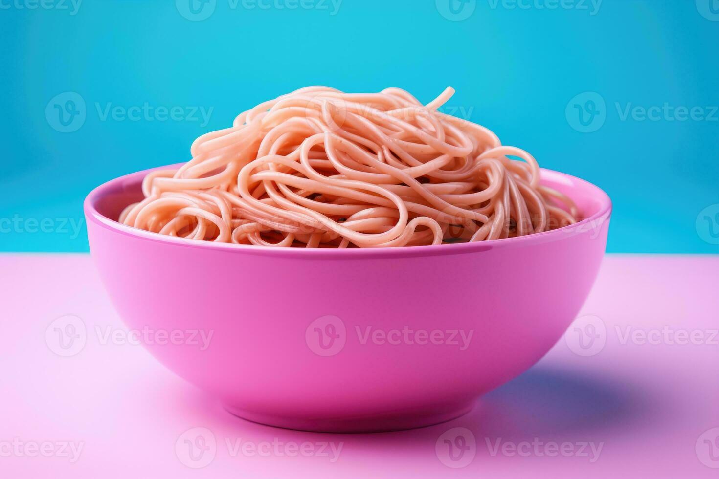 Bright color changing noodles in bowl isolated on a pink gradient background photo