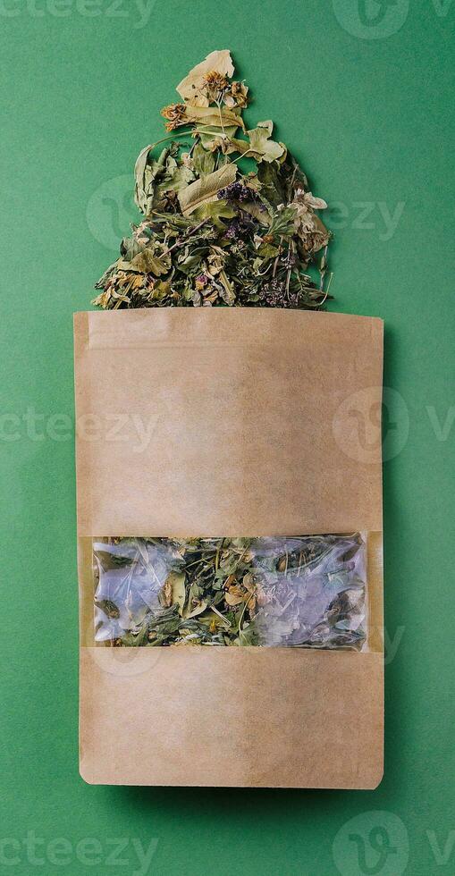Paper bags with scattered different dried tea photo
