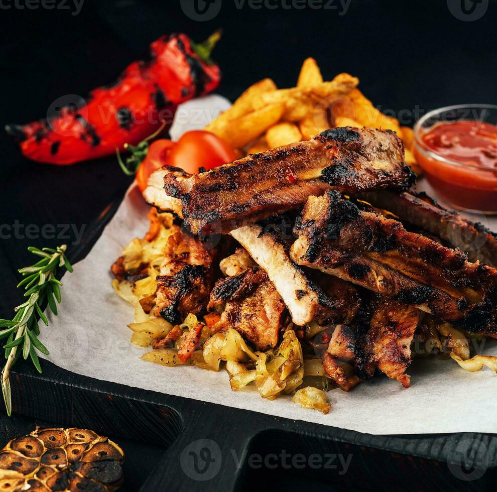 Close up gourmet main dish with grilled pork rib and fried potatoes photo