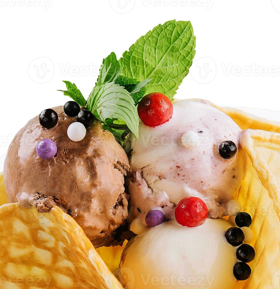 Three scoops of natural organic fruit ice cream in a wafer cup photo