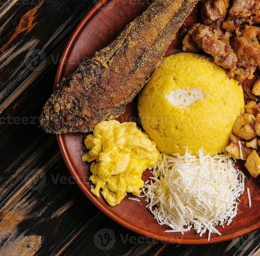 Traditional Moldavian hominy porridge on a wooden tray photo