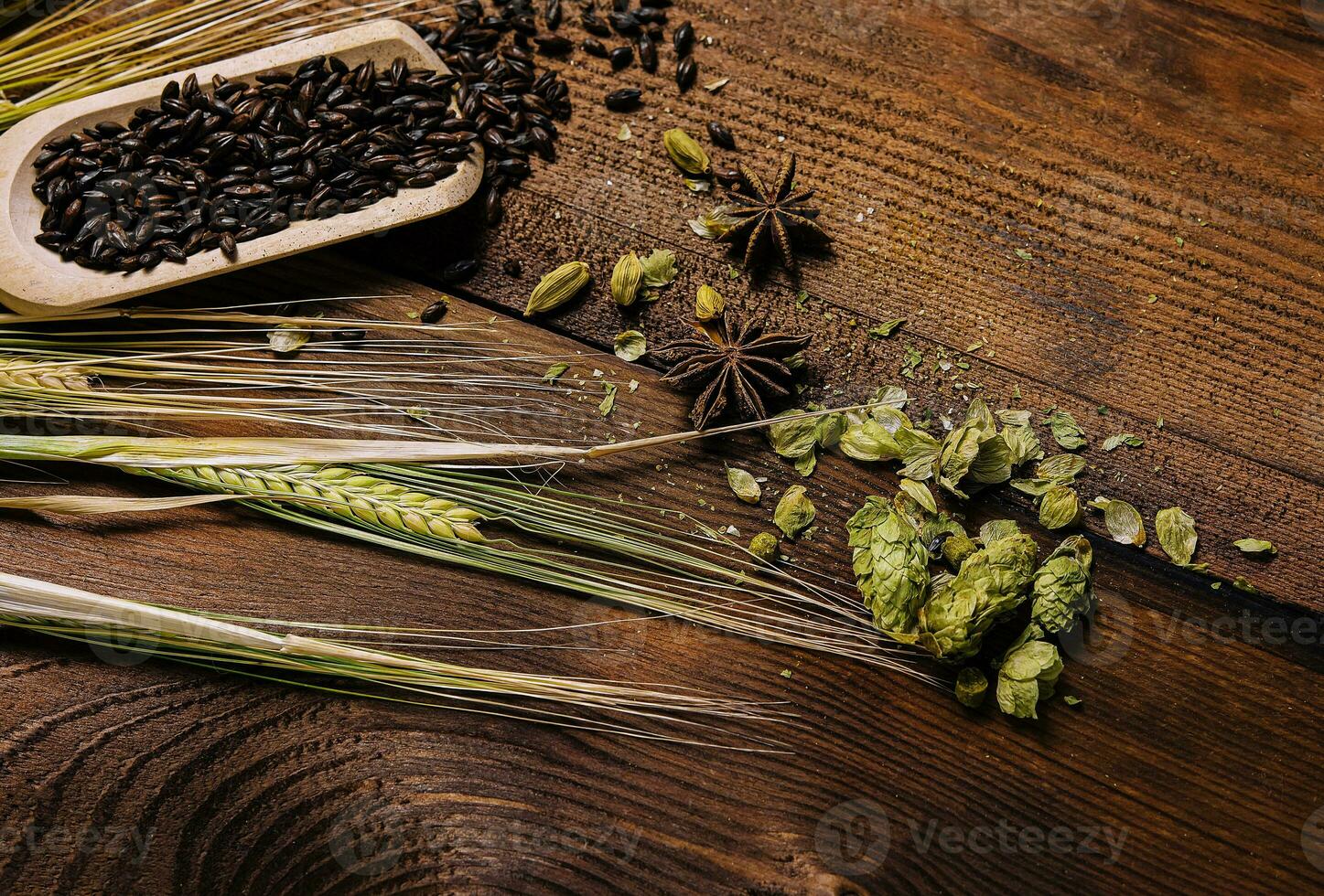 wheat with hops and cinnamon on a wooden background photo