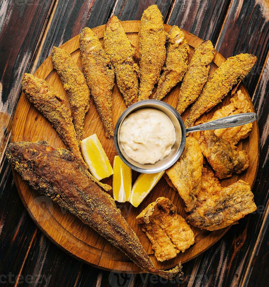 fried red mullet fish on wooden board photo