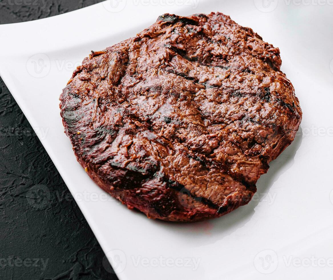 steak on white plate close up photo