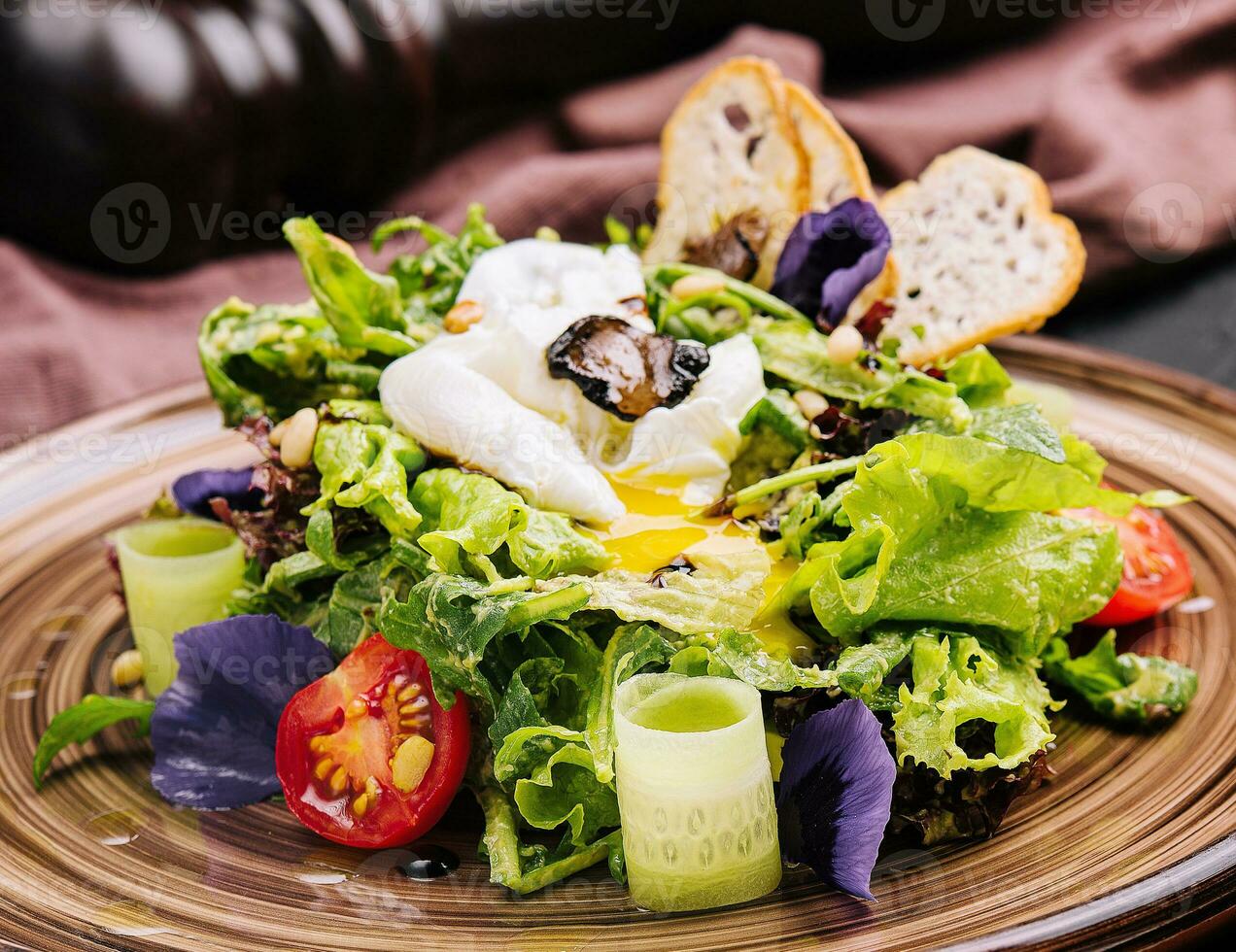 Vegetable salad with poached egg on a plate photo