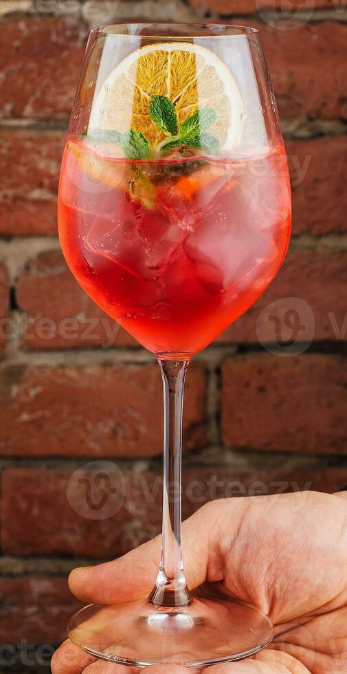 Fresh cold strawberry alcoholic drink with orange, ice and mint photo
