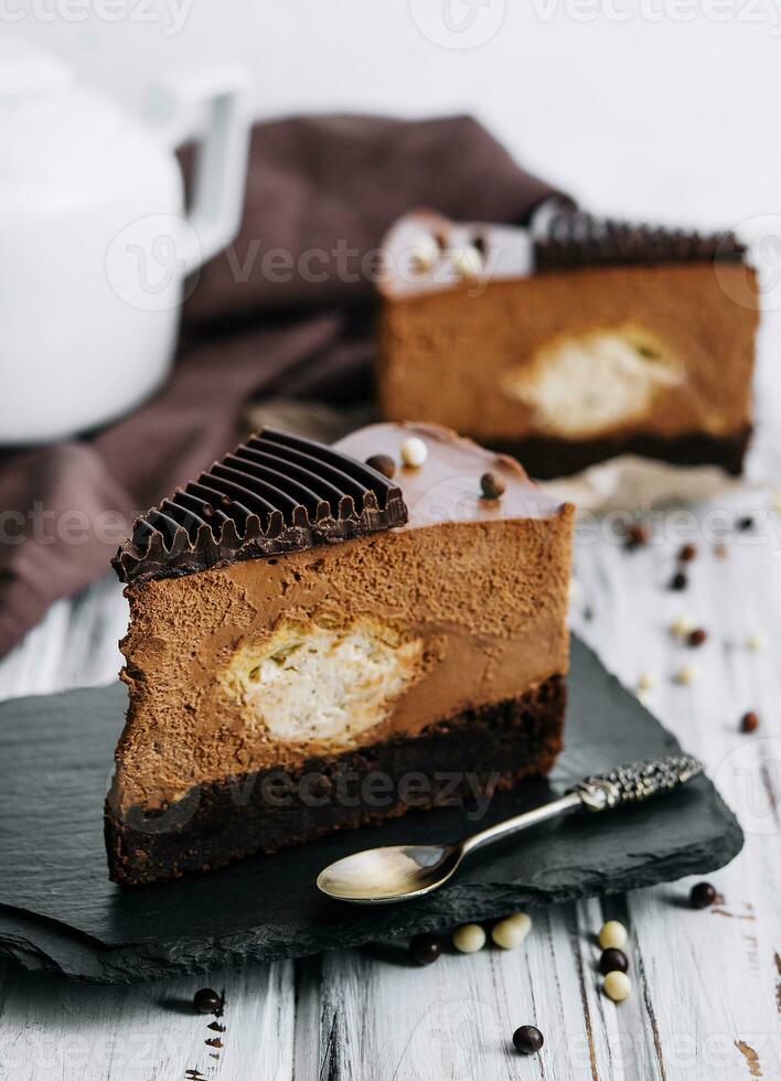 A piece of chocolate cake with tea photo