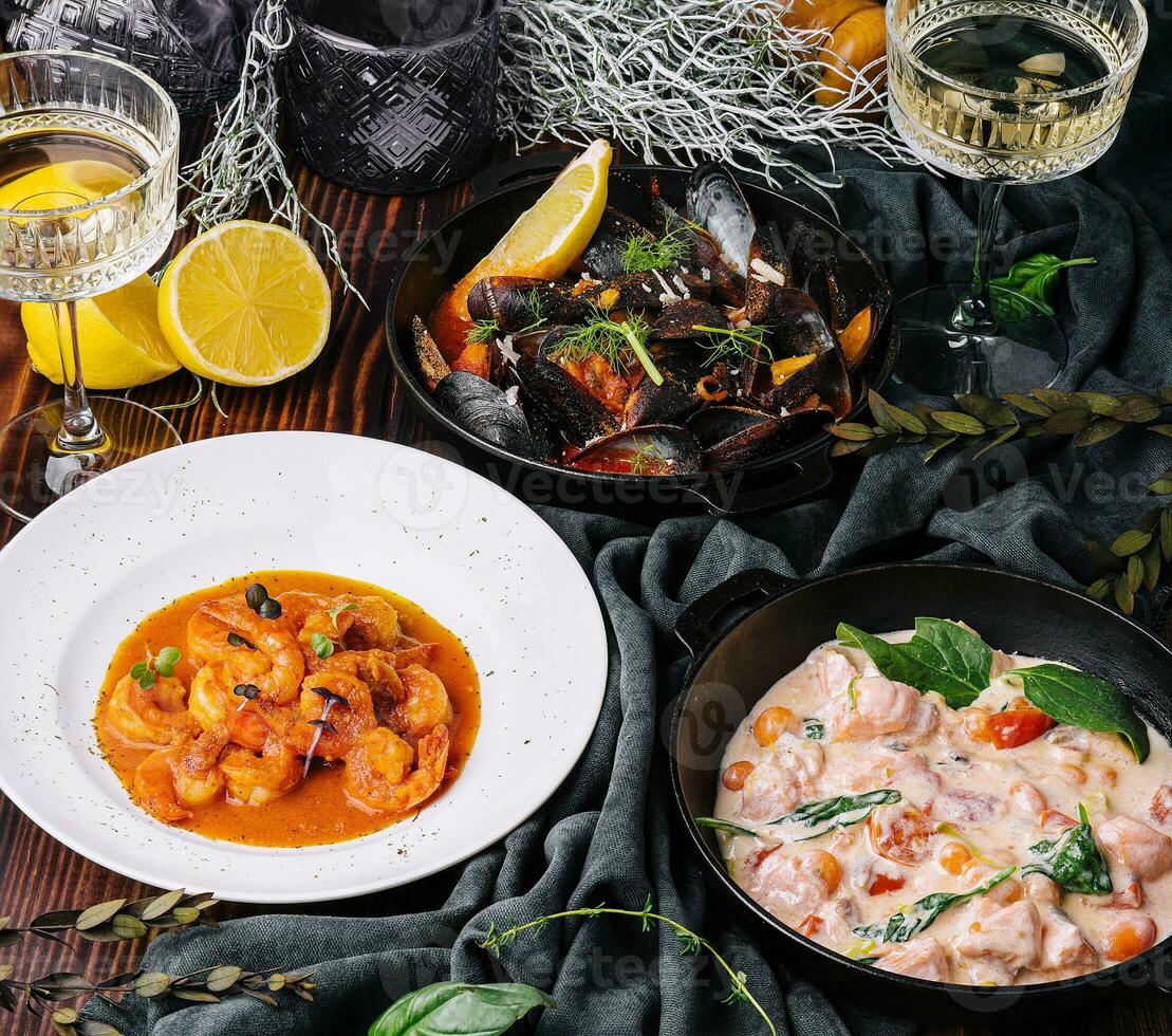 Salmon in cream sauce, Shrimp in Romesco sauce and Mussels photo