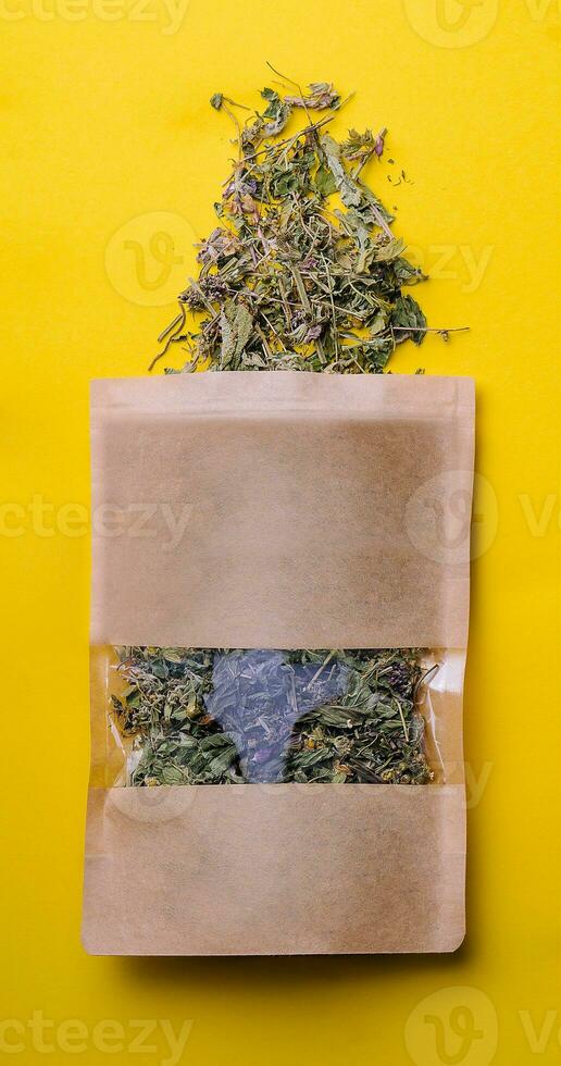 Paper bag with scattered different dried tea photo