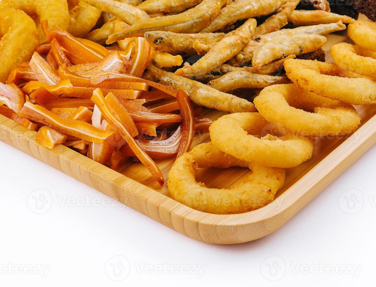 onion rings, fried smelt, pork ears on board photo