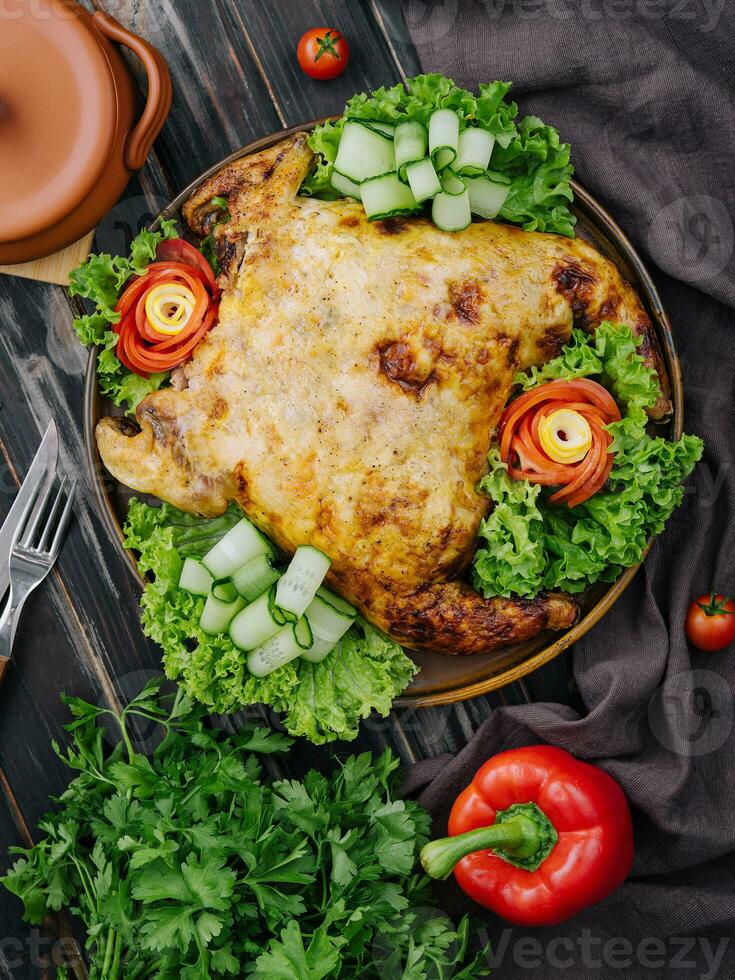 Roast chicken with fresh vegetables top view photo