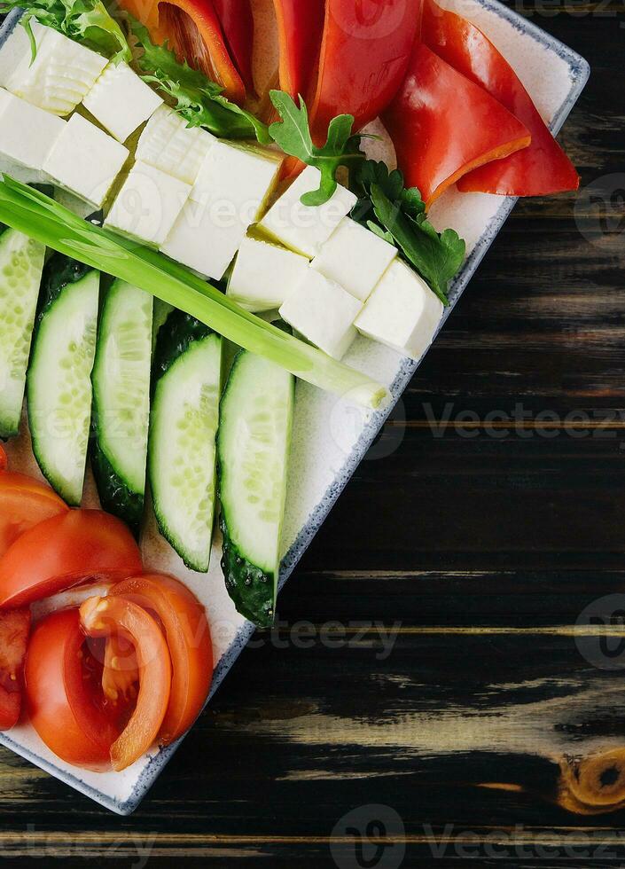 chopped vegetables with goat cheese on a plate photo