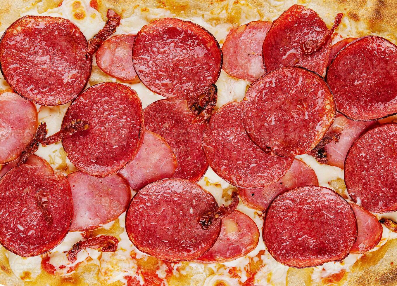 Pepperoni pizza close up background or texture photo