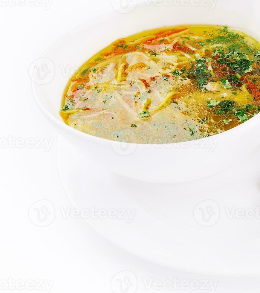 Chicken soup or broth with noodles, herbs and hot green pepper photo
