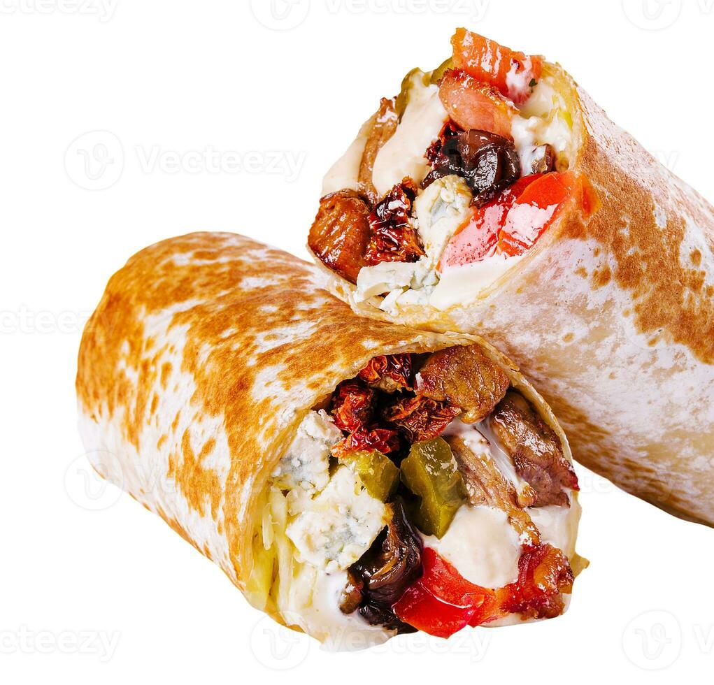 fresh roll of thin lavash or pita bread filled with grilled meat photo