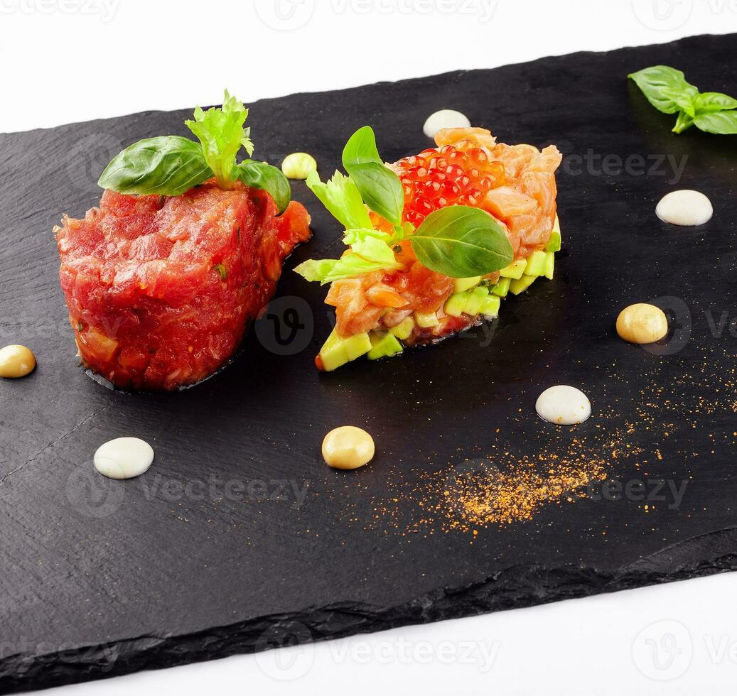 salmon and beef tartare on black board photo