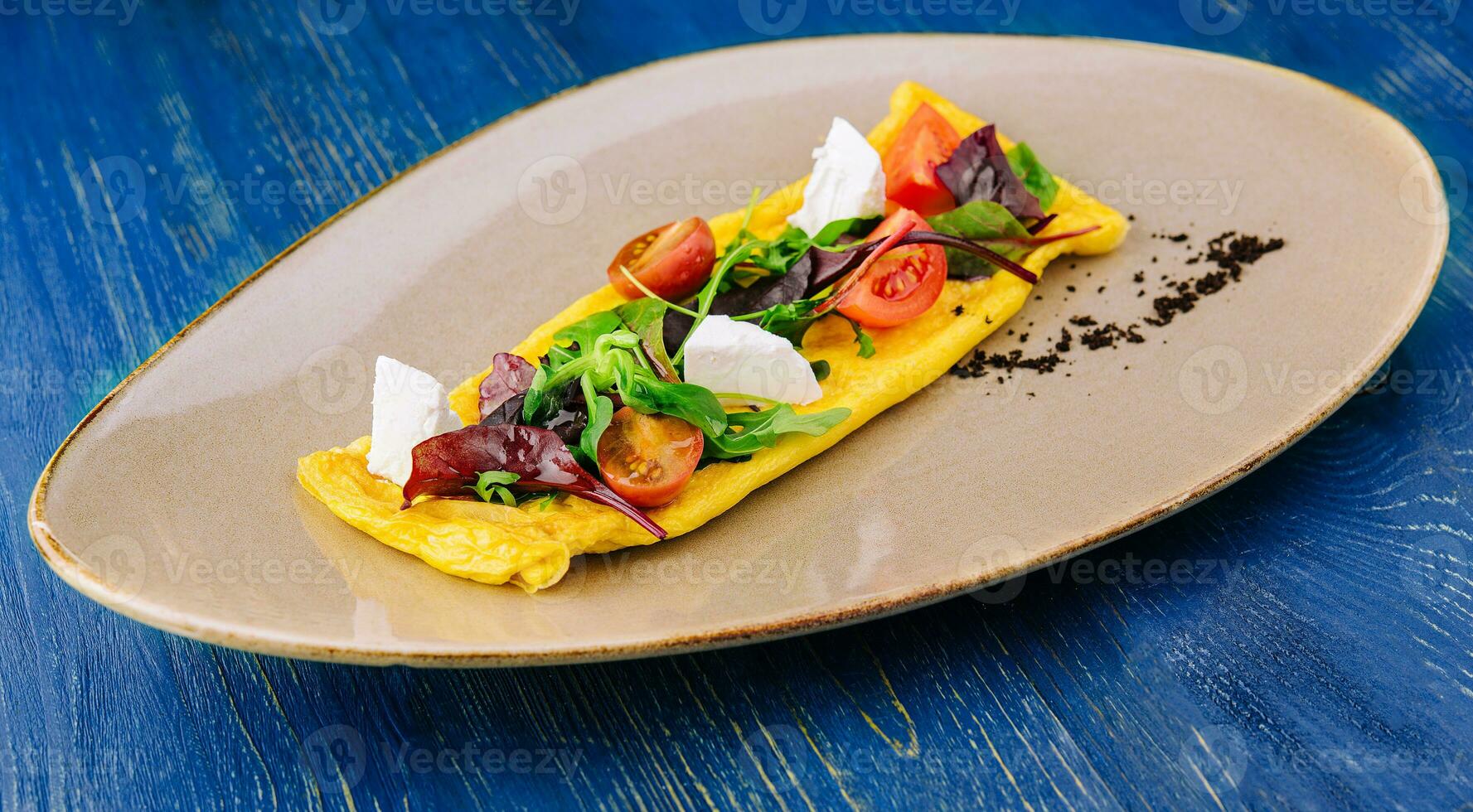 Omelette with cherry tomatoes and goat cheese photo