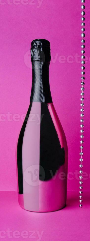 champagne bottle on pink background photo