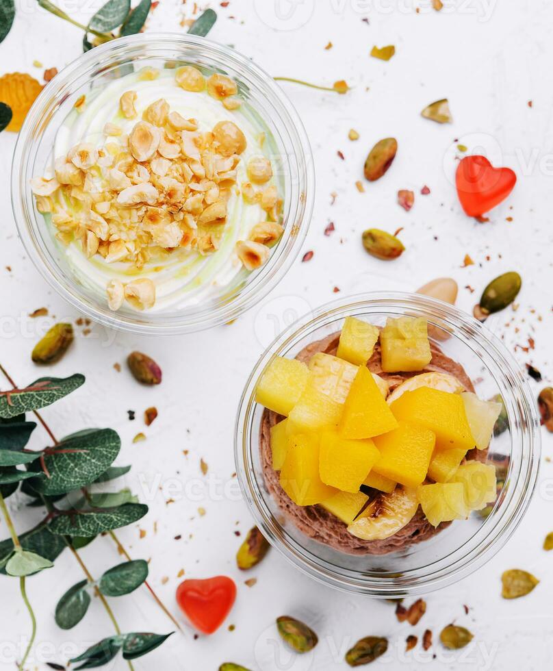 Soft chocolate and vanilla ice cream with pistachio, mango and jelly photo