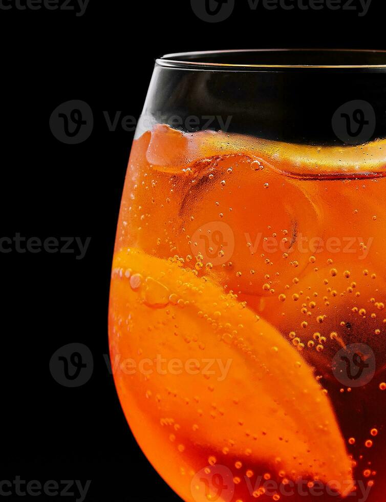 glass of aperol spritz cocktail on black background photo