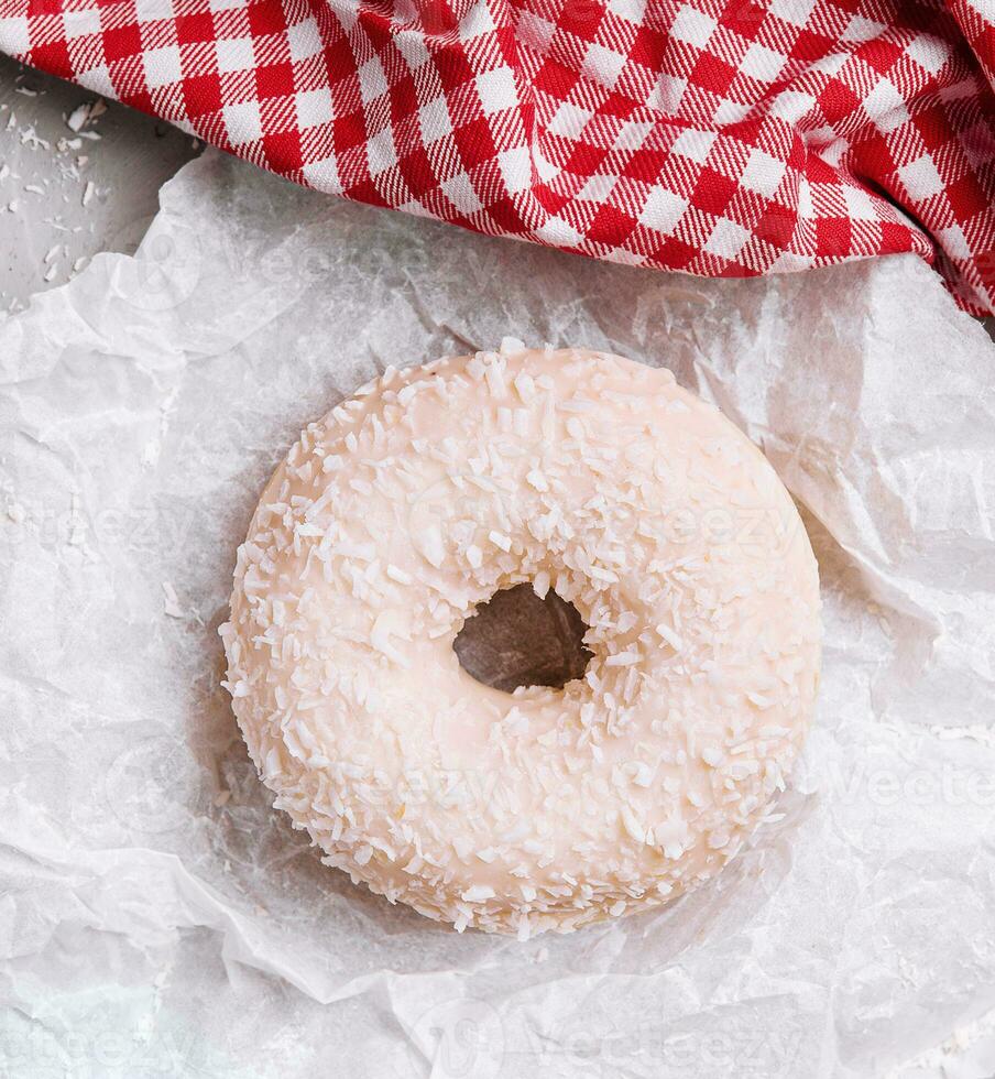 sweet donut with coconut flakes, top view photo