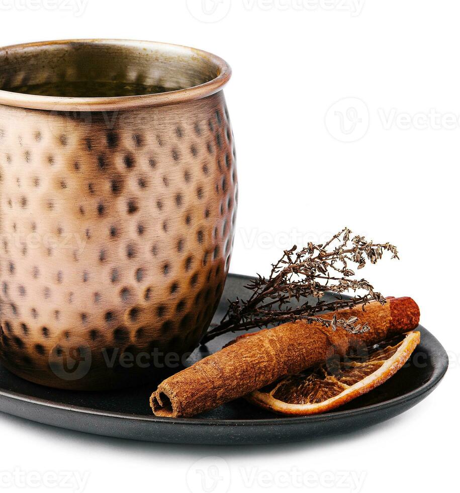 Mulled wine in vintage metal mug with cinnamon photo